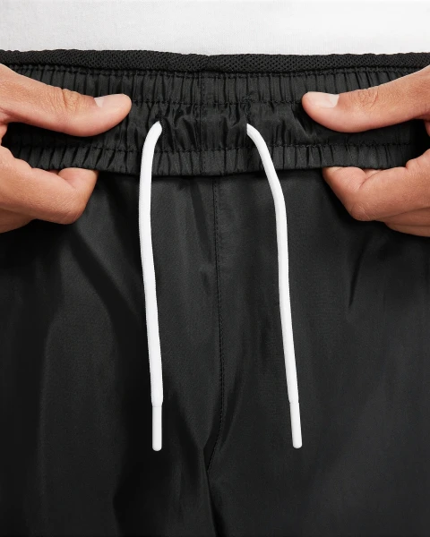 Спортивні штани Nike WINDRUNNER WOVEN LINED PANTS чорні DX0653-011